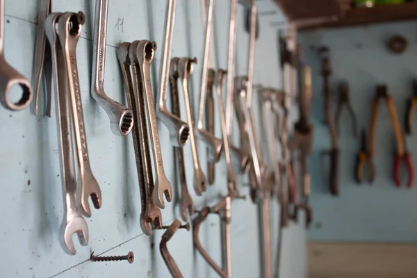 keys in the garage tools. Old tools hanging on wall in workshop , Tool shelf against a wall  in the garage