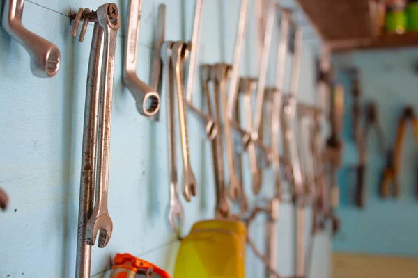 keys in the garage tools. Old tools hanging on wall in workshop , Tool shelf against a wall  in the garage