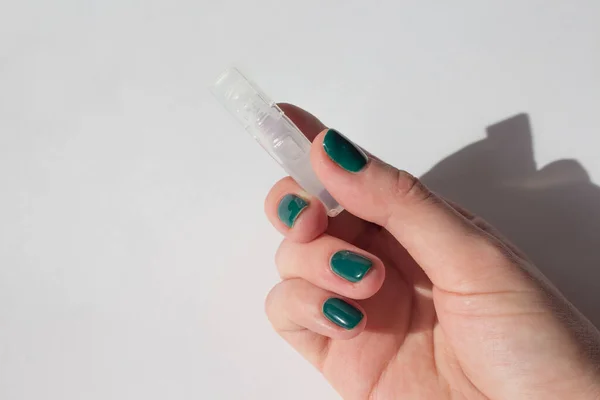 woman holds vaccine in her hand. ampoule with vaccine in hand close up.concept vaccination and treatment of coronovirus.