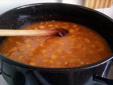 Metal tencerede şeftali meyve pişirme ve ev yapımı reçel hazırlanması ahşap kaşıkla karıştırın