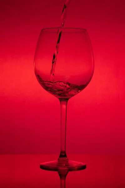 Remplissage Verre Verser Verre Vin Sur Fond Rouge — Photo