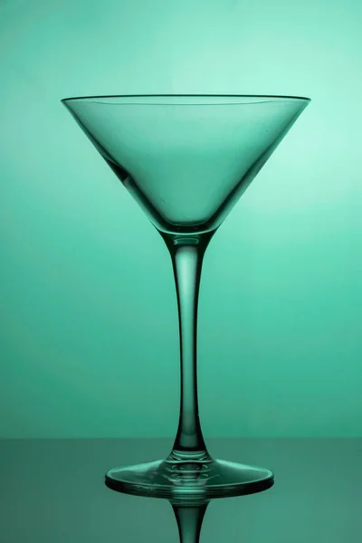 Cocktail glass, the stemmed glass is lit with teal light