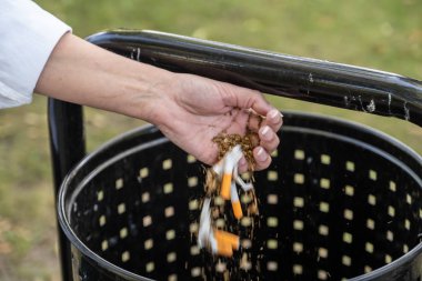 bir kadın buruşturuyor ve sigara kırıyor ve tr onları atar