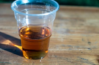 Ahşap bir masa üzerinde bira ile Plastik cam