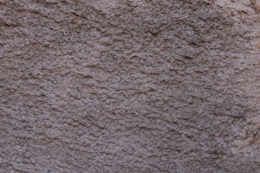 Açık kahverengi dokulu sıvalı duvar. Soyut desen.