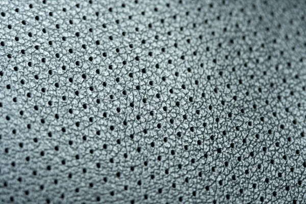 Close-up of perforated leather. trim gray leather for car seats.