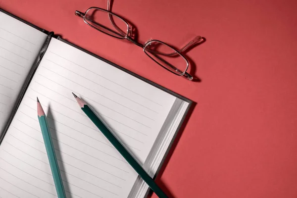 Notebook Glasses Two Pencils Red Background Business Education Concept — Stock Photo, Image