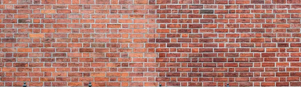 Beyaz gruplandırmalı büyük kırmızı tuğladan bir panorama. Eski, desenli tuğla arka plan.