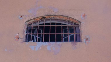 Paslı metal parmaklıkları olan geniş bir hapishane penceresi aç. Duvardaki pencere..
