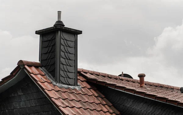 Chimney on the roof. Small-town buildings. Roofs of the city.