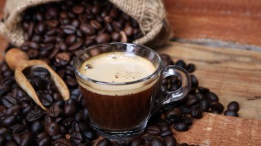 Kahve fincanı kahve çekirdekleri, çuvala ve tarçın ile