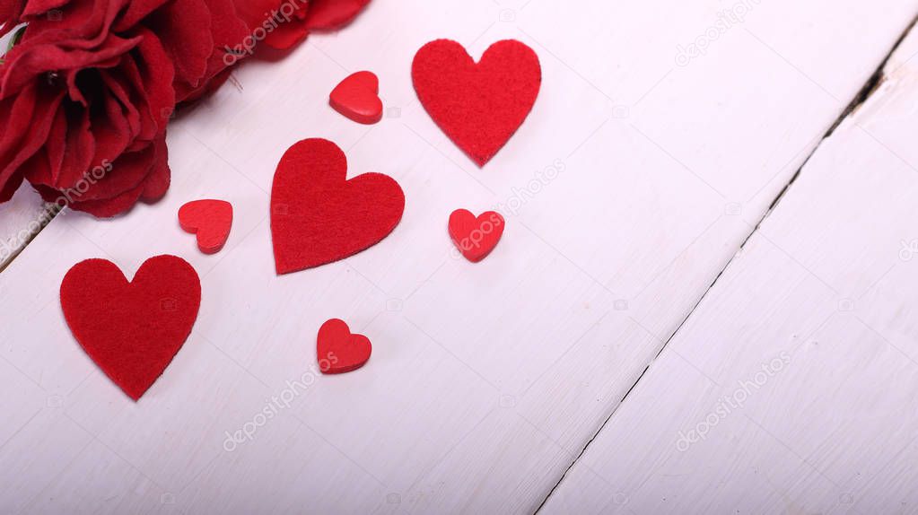 Happy Valentine's Day with red roses, white table, and red hearts