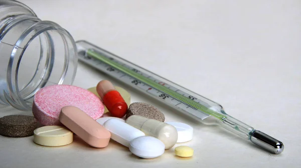 Apotheek thema, tabletten, pillen capsule heap mix therapie drugs met geneeskunde antibioticum en thermometer. Close-up van capsules. Geneeskunde achtergrond voor medisch concept. — Stockfoto
