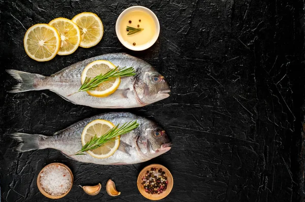 Raw Sea Bass Served Rosemary Twigs Lemon Slices Spices Stone — Stock Photo, Image