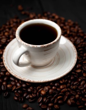 Kahve çekirdekleri ile siyah taş arka planda kahve taze fincan 