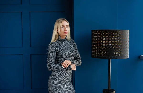 Jonge Blonde Vrouw Grijze Stijlvolle Jurk Poseren Blauwe Studio Interieur — Stockfoto