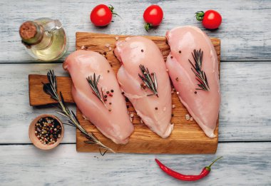 Çiğ tavuk göğüsleri baharat ve biberiye ile marine domates ve zeytinyağı ile servis 