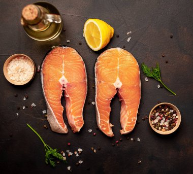 Siyah taş arka plan üzerinde baharat ve limon ile taze çiğ somon biftek