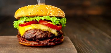 Ahşap arka planda bıçak yapışabilir taze ev yapımı Burger