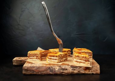 Ahşap tahta üzerinde fındık ve sıkışmış çatal ile geleneksel Türk baklavası veya baklava