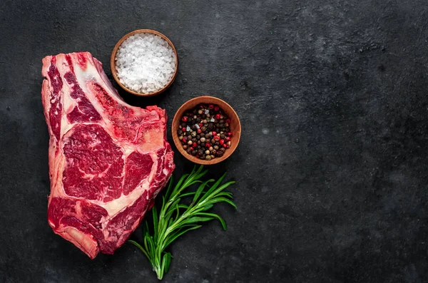 stock image raw meat with spices and herbs on black stone background