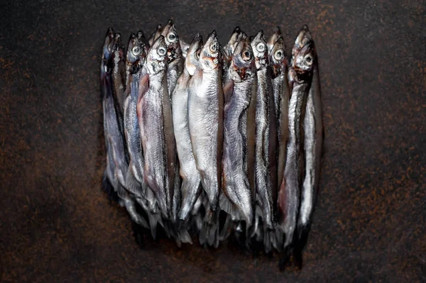 Top view on smelt fishes  on dark background