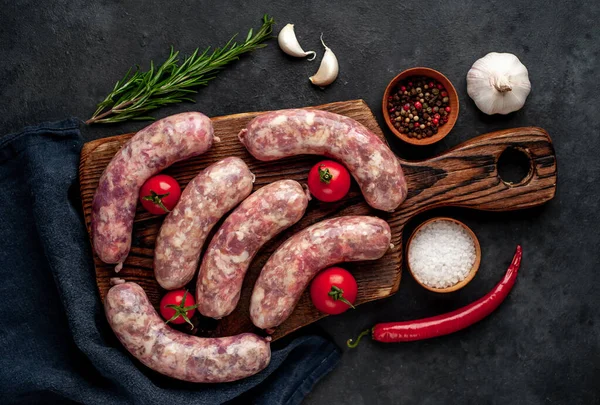 Raw Sausages Grill Spices Cutting Board Stone Background — Stock Photo, Image
