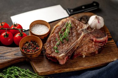 Biftek ızgarası ve taştan arka planda et bıçağının malzemeleri.