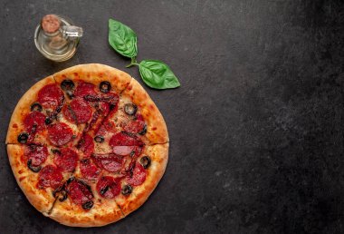 Salamlı pizza pepperonisi, mozarella, zeytin, arka planda Provencal otlar.