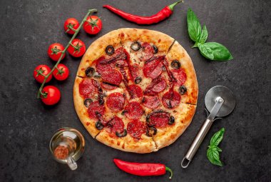 Salamlı pizza pepperonisi, mozarella, zeytin, arka planda Provencal otlar.