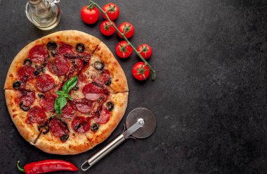 Salamlı pizza pepperonisi, mozarella, zeytin, arka planda Provencal otlar.