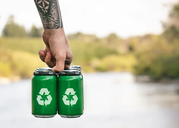 Man holding cans with recycle symbol. Recycling concept.