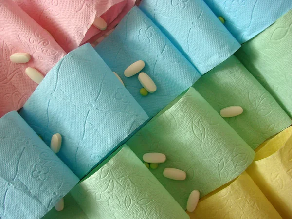 Colored toilet paper and pills on it
