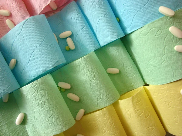 Colored toilet paper and pills on it