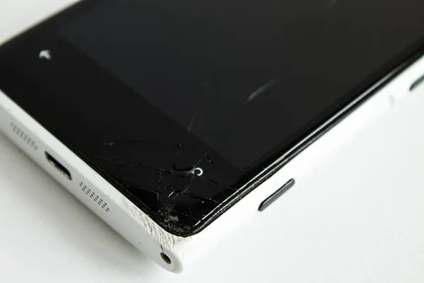 Broken screen smartphone with a cracked screen closeup