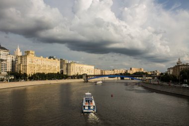Moscow / Russia - July, 18, 2019: view of the Moscow river and embankments with historic buildings on a cloudy summer day clipart