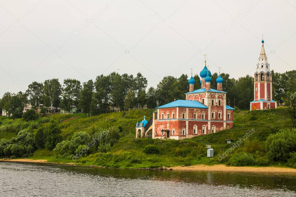 Red Kazan Church on the high hilly Bank of the Volga river on a cloudy summer day and space for copying in Tutaev Russia
