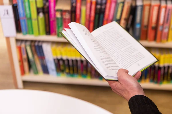 An Old Man Reading A Book In The Library. Selective Focus, Hands Close Up