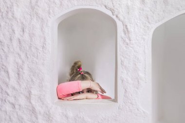 Tuz Mağarası'nın İçindeki Çocuk Oyun Evi'nde oynayan küçük kız. Gizleme Yüzü, Onun Clasped Hands Through Peeping, Kamera Bakıyor