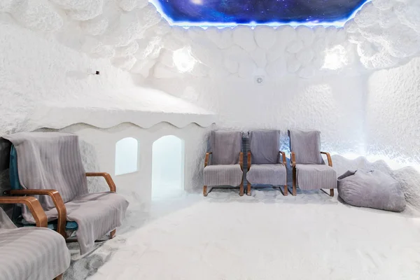 Salt Cave Interior With Textured Walls. Room For Halotherapy Sessions With Chairs For Patients And Children\'s Playhouse.
