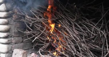 Pişirmeden önce şöminenin içinde ince dallar yanıyor. Barbekü Kızartması İçin Üzüm Yağı. Kömürü ızgaradan önce hazırlayın. Kakhety, Georgiathe Grapevine Et Izgarasından Önce Yanar