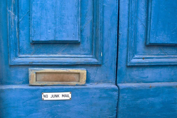 No Junk Mail sign under the door mail slot