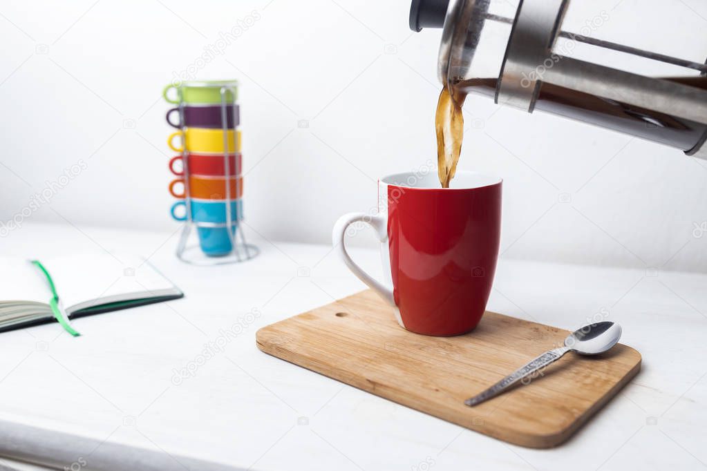 Kaffee aus Kanne gegossen neben Notizbuch / Coffe and Planner on the Breakfast Table