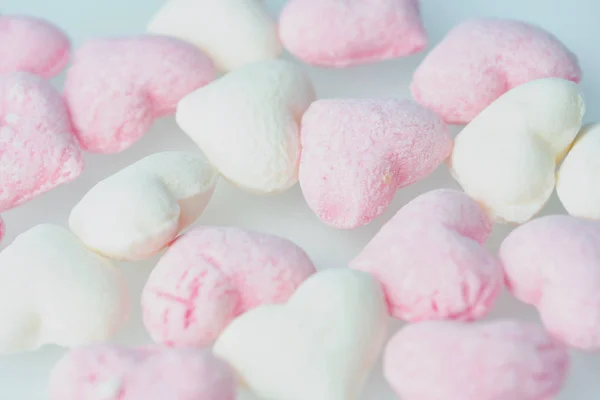 Pink and white sweets on a white surface as picture background — Stock Photo, Image