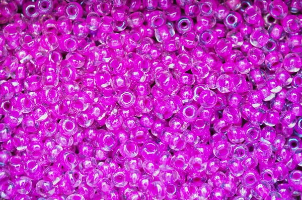 macro of pink shiny plastic beads as picture background