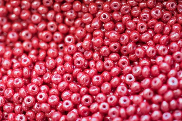 macro photo of red shiny plastic beads as background