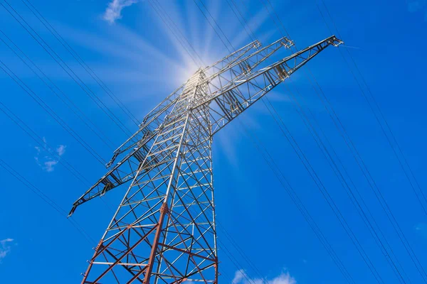 sun shines through a power pole in front of the blue sky in Germany a concept for solar energy