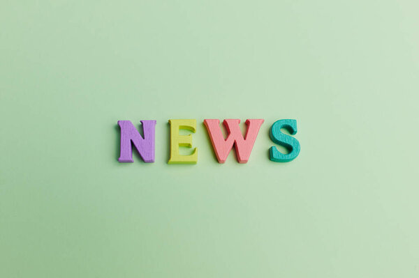 the word news on green background