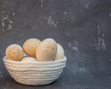 Bir hasır plaka sepeti dekoratif ahşap Paskalya yumurtaları