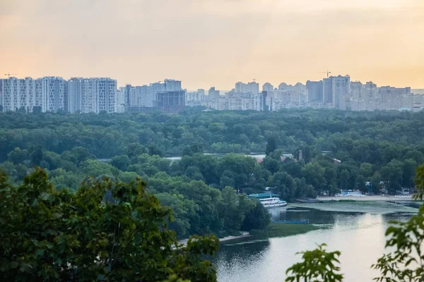 Tour of Kiev in the center of Europe. View of the Dnieper, Trukhanov island and a foot bridge. Park fountain and sunset on the horizon